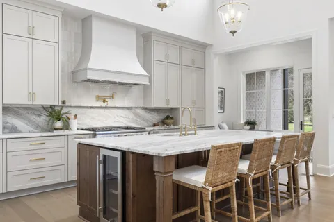 a kitchen with kitchen island a sink stove and cabinets