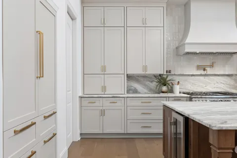 a living room with furniture a fireplace and potted plants