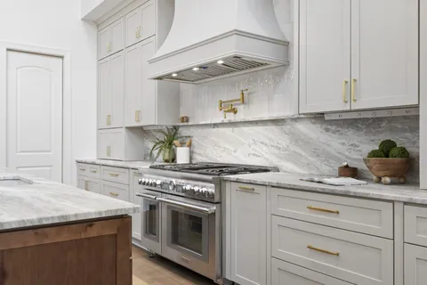 a white bath tub sitting in a bathroom next to a window