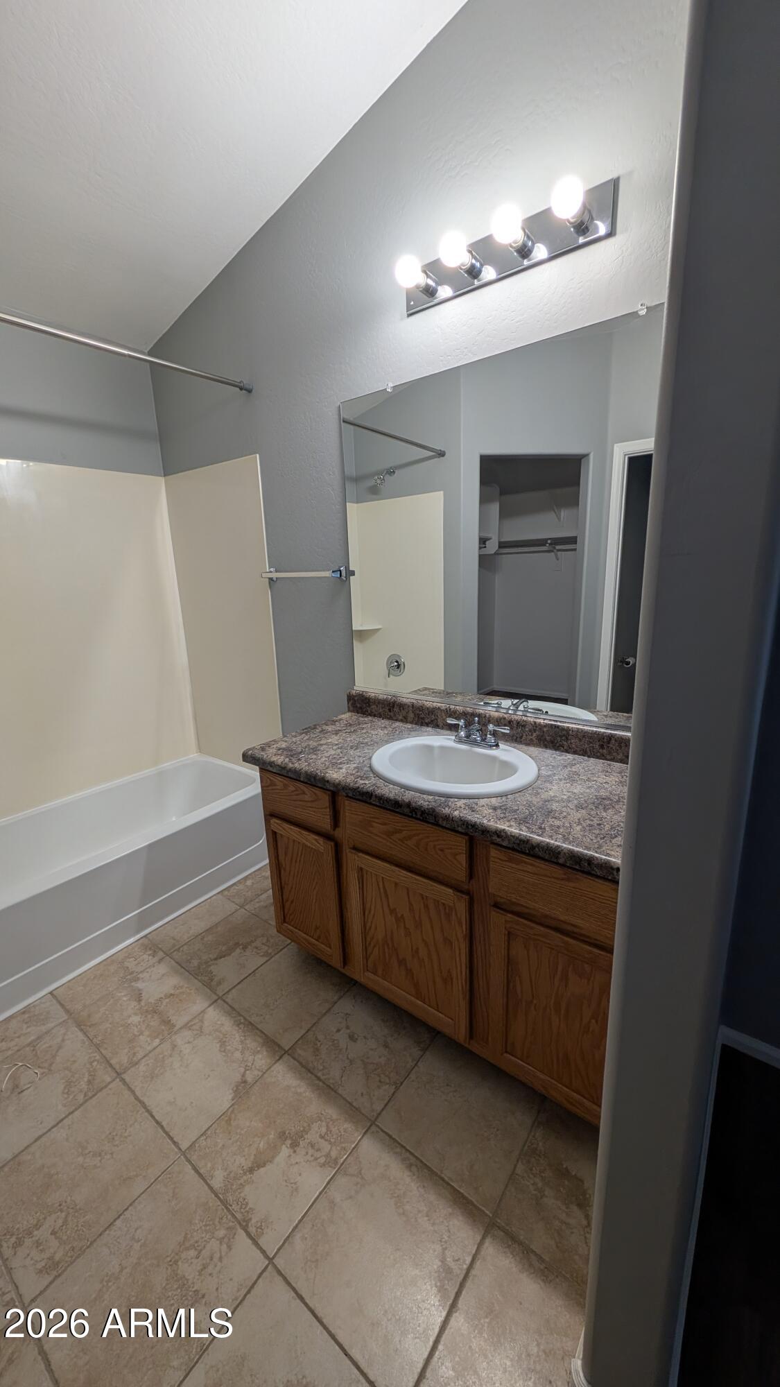 1377 East Pryor Road San Tan Valley, AZ 85140 - Photo 10 of 31 a bathroom with a granite countertop sink a mirror and a vanity