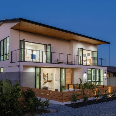 a front view of a building with lots of green space