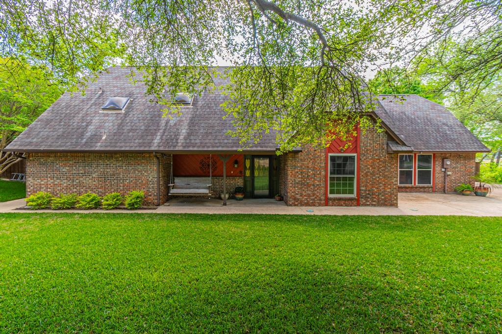 127 Nicklaus Nook Lancaster, TX 75146 - Photo 1 of 37 Back of house with a lawn, roof with shingles, and brick siding