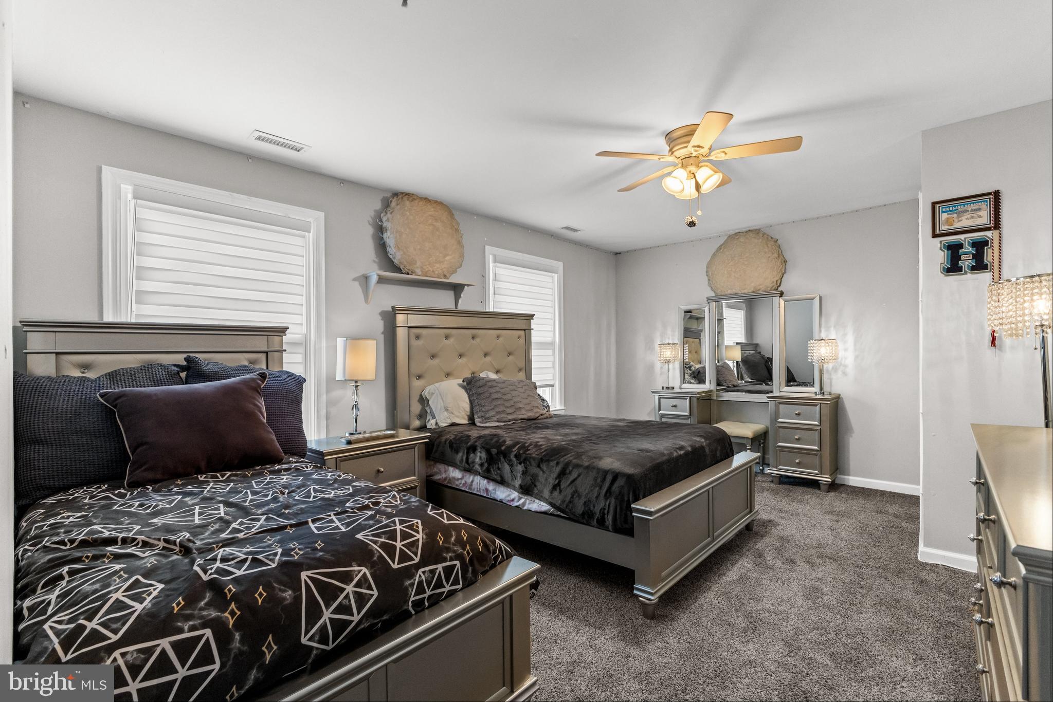 28 Windmill Clementon, NJ 08021 - Photo 24 of 28 a spacious bedroom with a bed and a chandelier