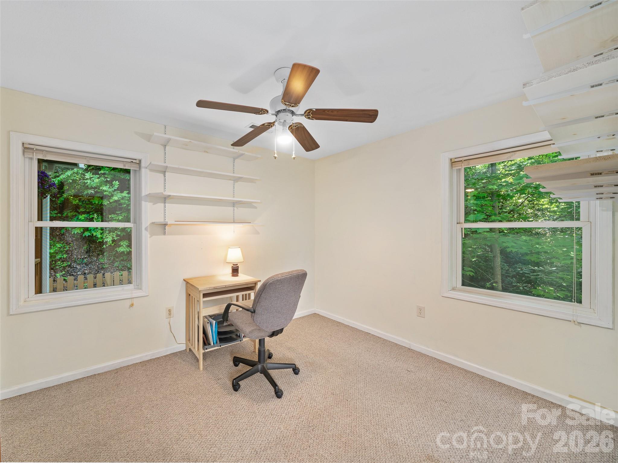 142 Wildflower Road Spruce Pine, NC 28777 - Photo 17 of 46 a view of a workspace with furniture and a window