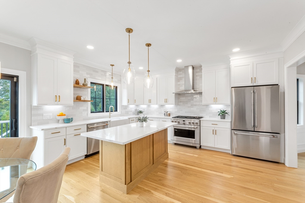 10 Starling Street Boston, MA 02132 - Photo 11 of 36 a kitchen with stainless steel appliances granite countertop a sink stove and refrigerator