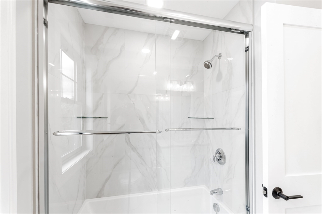 10 Starling Street Boston, MA 02132 - Photo 21 of 36 a bathroom with a shower and a bath tub