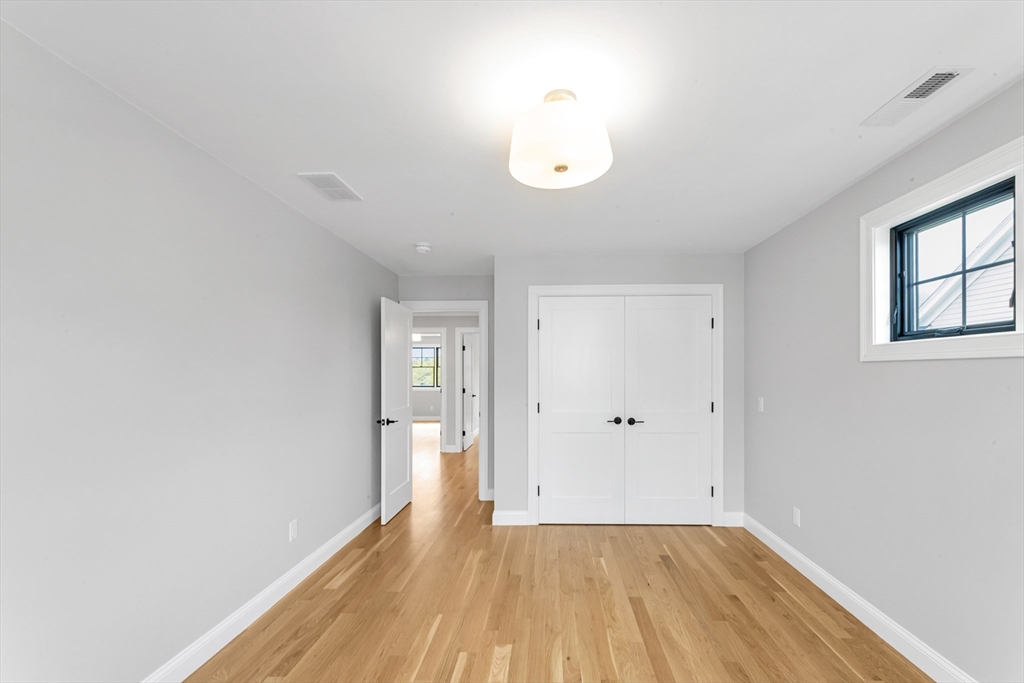 10 Starling Street Boston, MA 02132 - Photo 23 of 36 a view of a room with wooden floor and a window