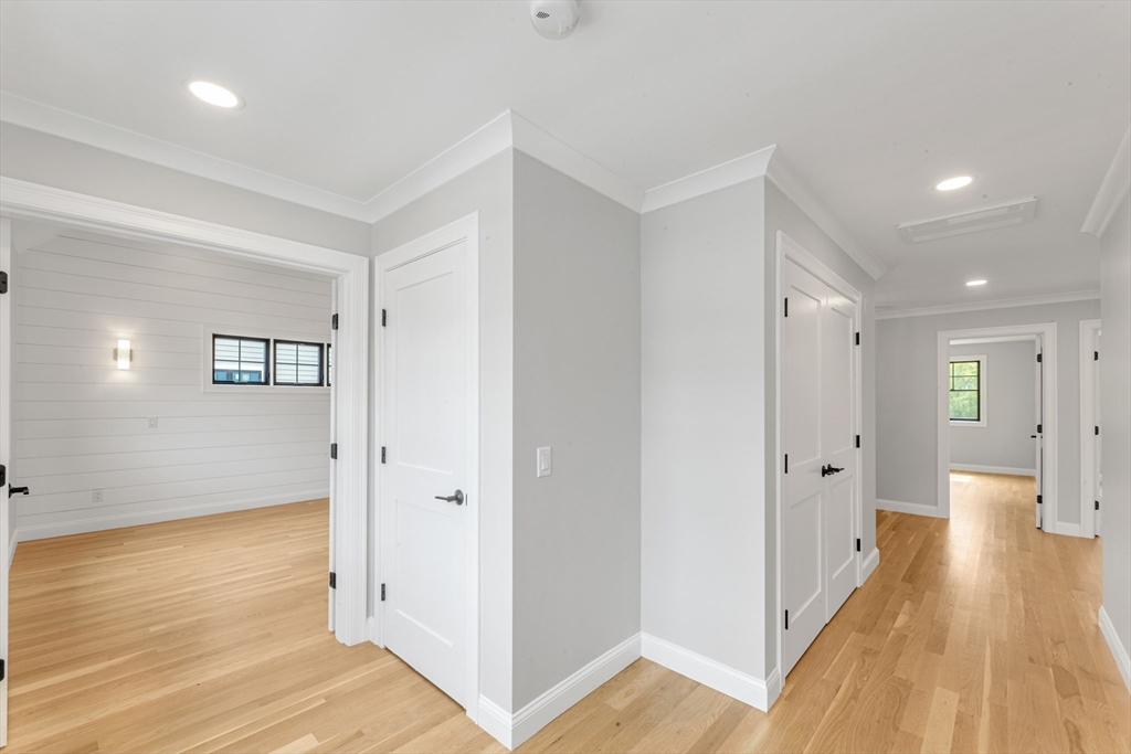 10 Starling Street Boston, MA 02132 - Photo 24 of 36 a view of a hallway with wooden floor and a bathroom