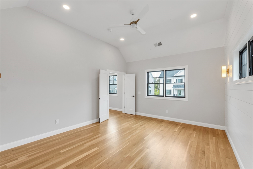 10 Starling Street Boston, MA 02132 - Photo 27 of 36 an empty room with wooden floor and windows
