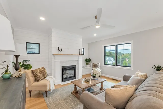 a living room with furniture fireplace and window