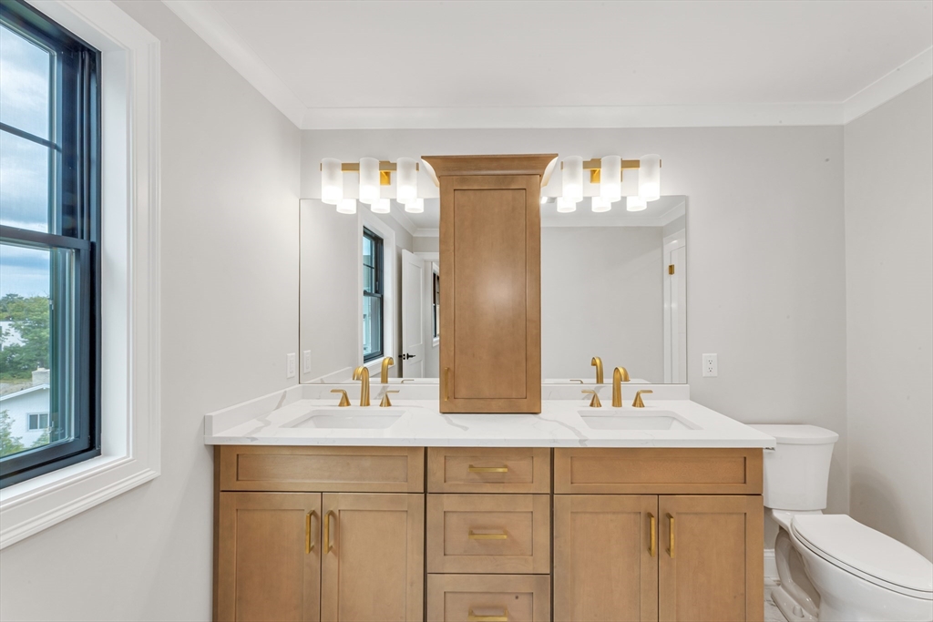 10 Starling Street Boston, MA 02132 - Photo 31 of 36 a bathroom with a double vanity sink and a mirror
