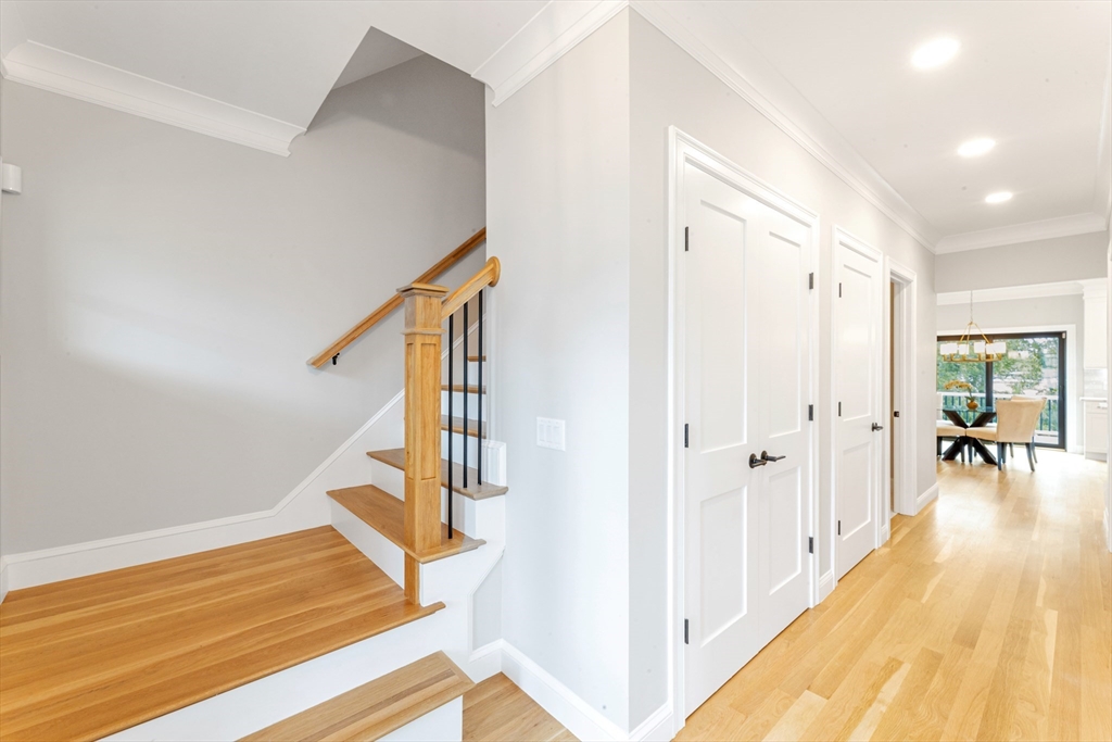 10 Starling Street Boston, MA 02132 - Photo 33 of 36 a view of a hallway with wooden floor and staircase