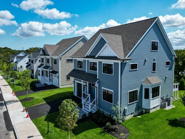 a aerial view of a house next to a yard