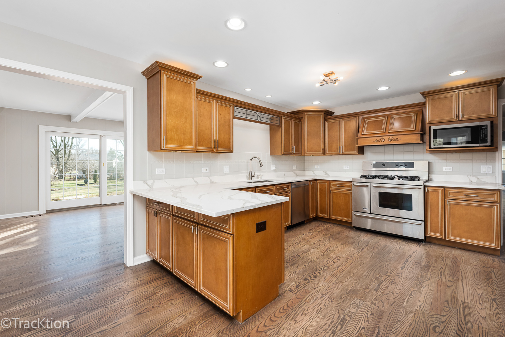 1212 Gartner Road Naperville, IL 60540 - Photo 11 of 32 a kitchen with stainless steel appliances granite countertop a stove a sink and a refrigerator
