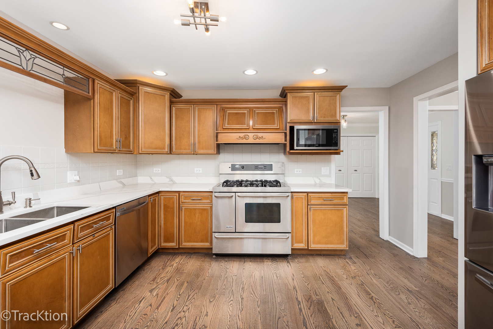 1212 Gartner Road Naperville, IL 60540 - Photo 12 of 32 a kitchen with stainless steel appliances granite countertop a stove and a sink