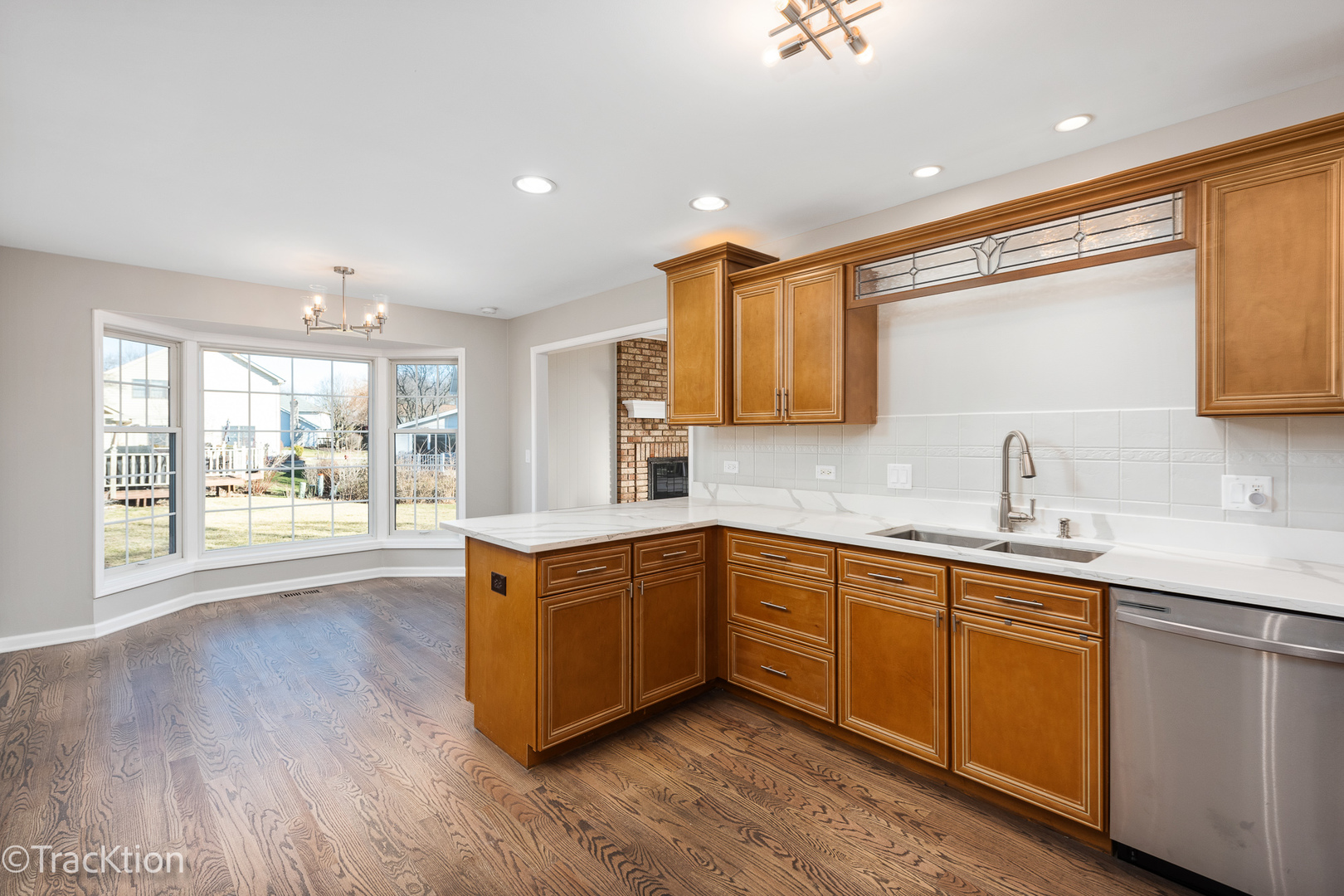 1212 Gartner Road Naperville, IL 60540 - Photo 13 of 32 a kitchen with stainless steel appliances granite countertop a sink cabinets and wooden floor