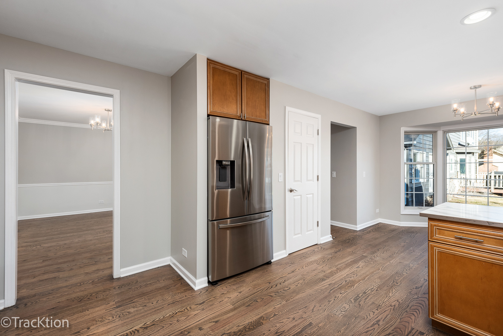 1212 Gartner Road Naperville, IL 60540 - Photo 14 of 32 a view of a kitchen with wooden floor and a refrigerator