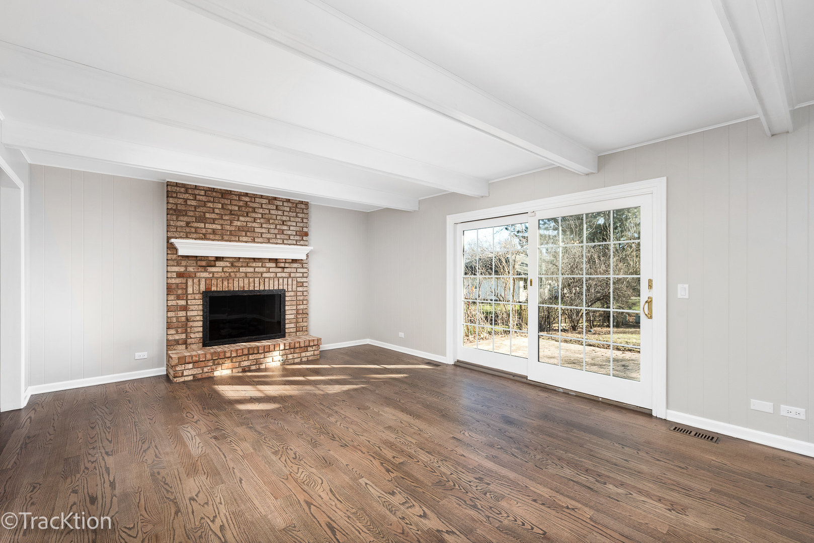 1212 Gartner Road Naperville, IL 60540 - Photo 8 of 32 a view of an empty room with a fireplace and a window