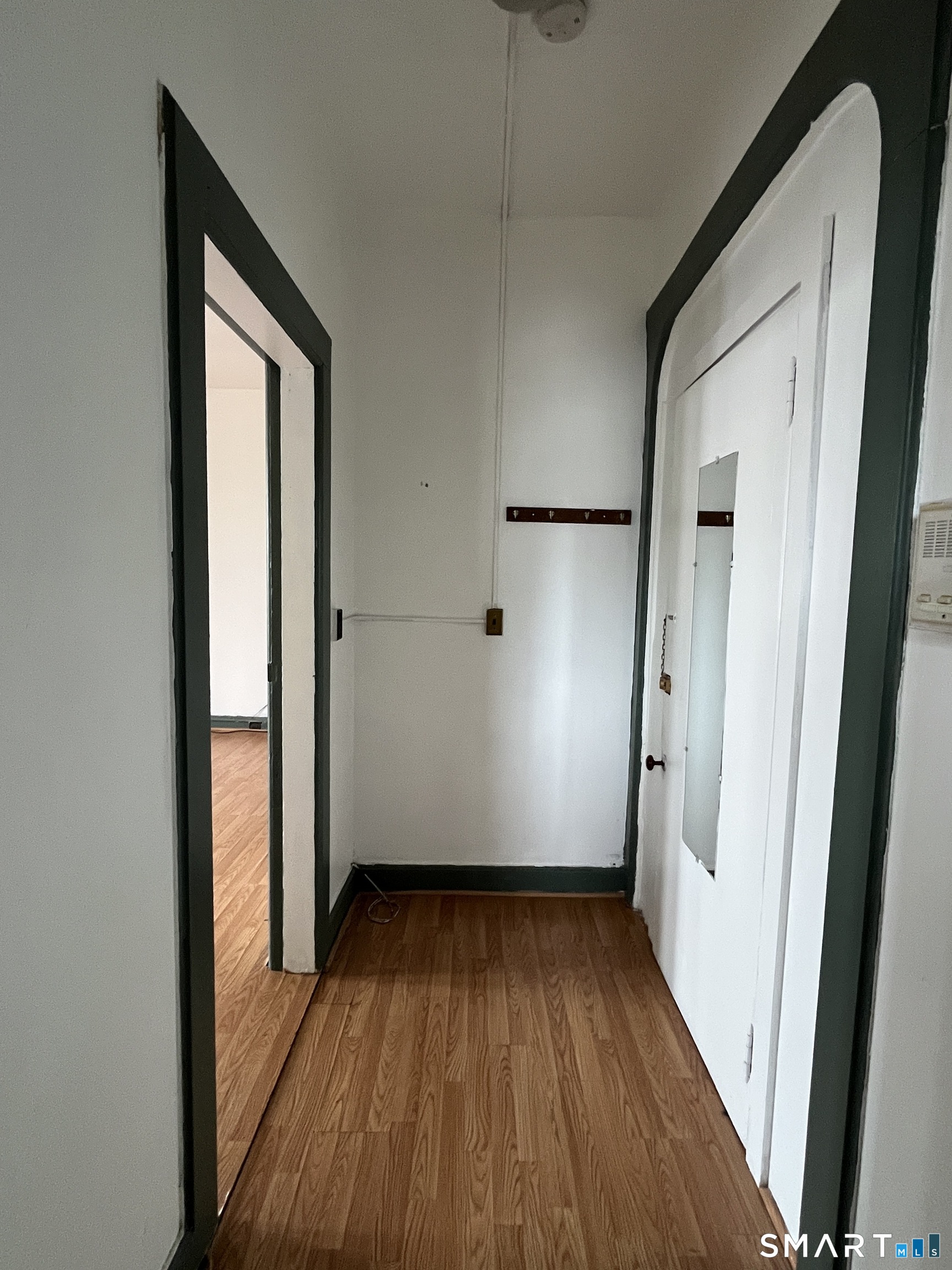 49 Edgewood Way, Unit 5 New Haven, CT 06515 - Photo 3 of 13 an empty room with wooden floor and entrance