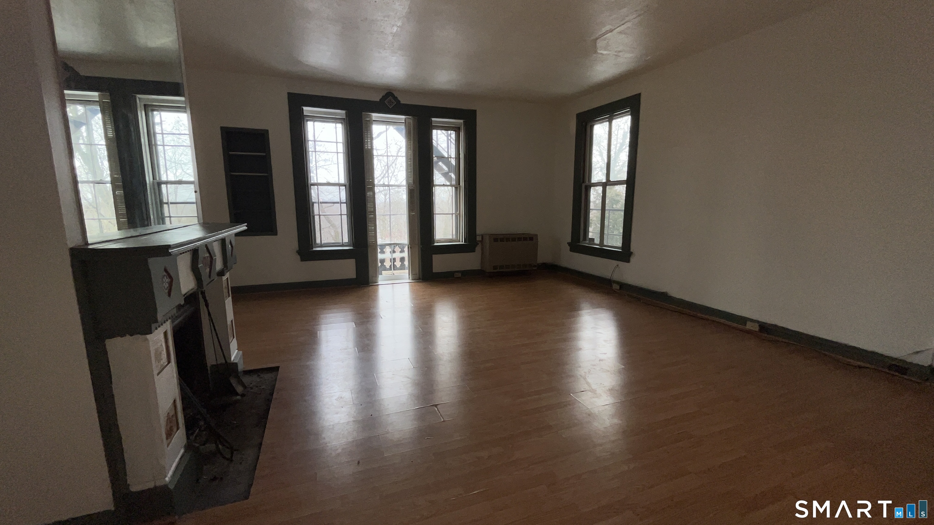 49 Edgewood Way, Unit 5 New Haven, CT 06515 - Photo 4 of 13 an empty room with wooden floor and windows