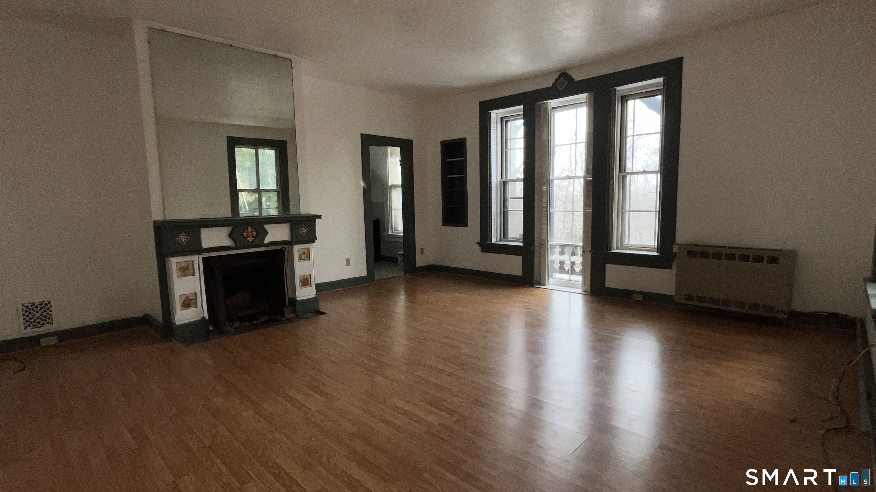 49 Edgewood Way, Unit 5 New Haven, CT 06515 - Photo 5 of 13 an empty room with wooden floor and windows