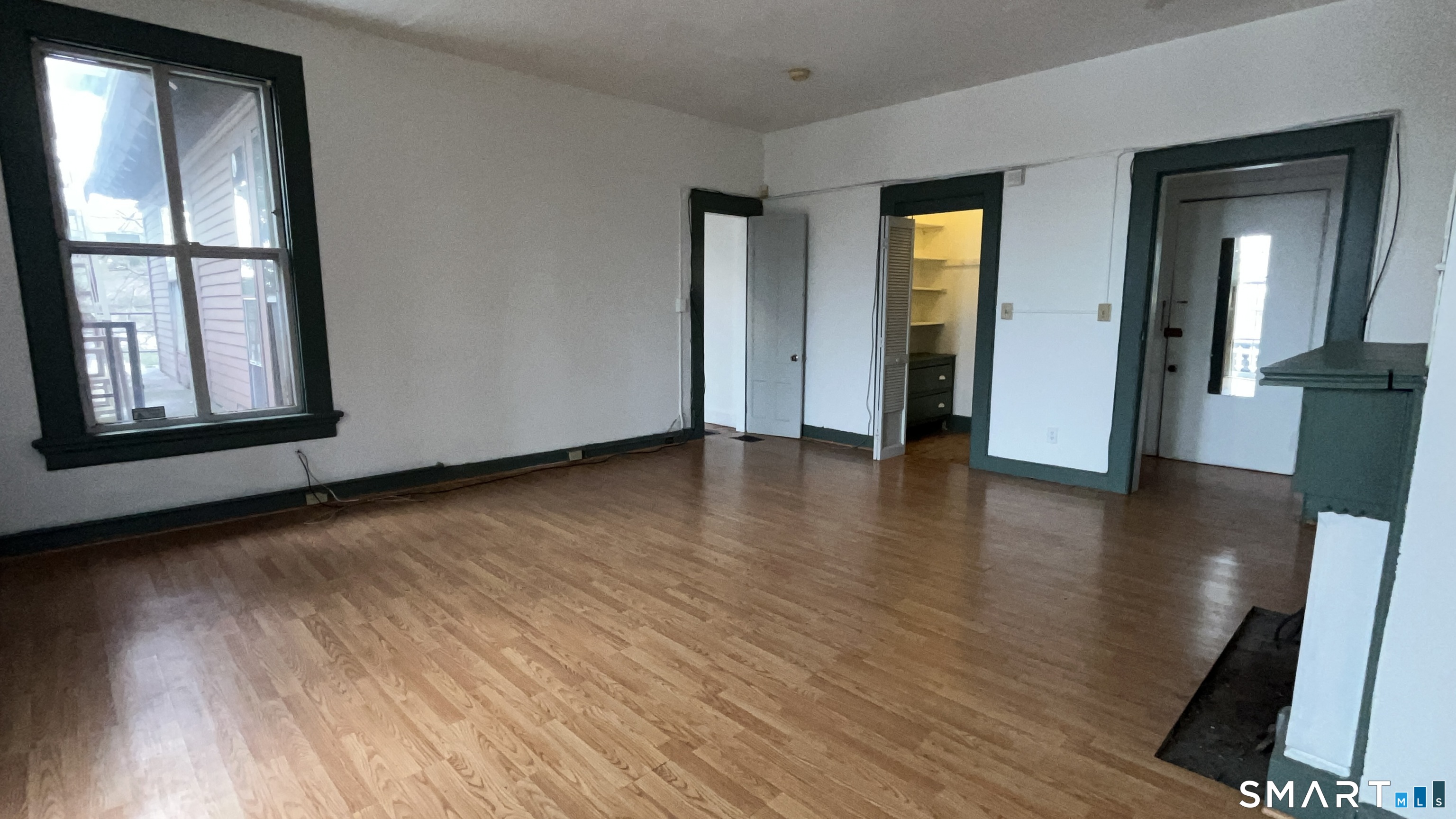 49 Edgewood Way, Unit 5 New Haven, CT 06515 - Photo 6 of 13 an empty room with wooden floor and windows