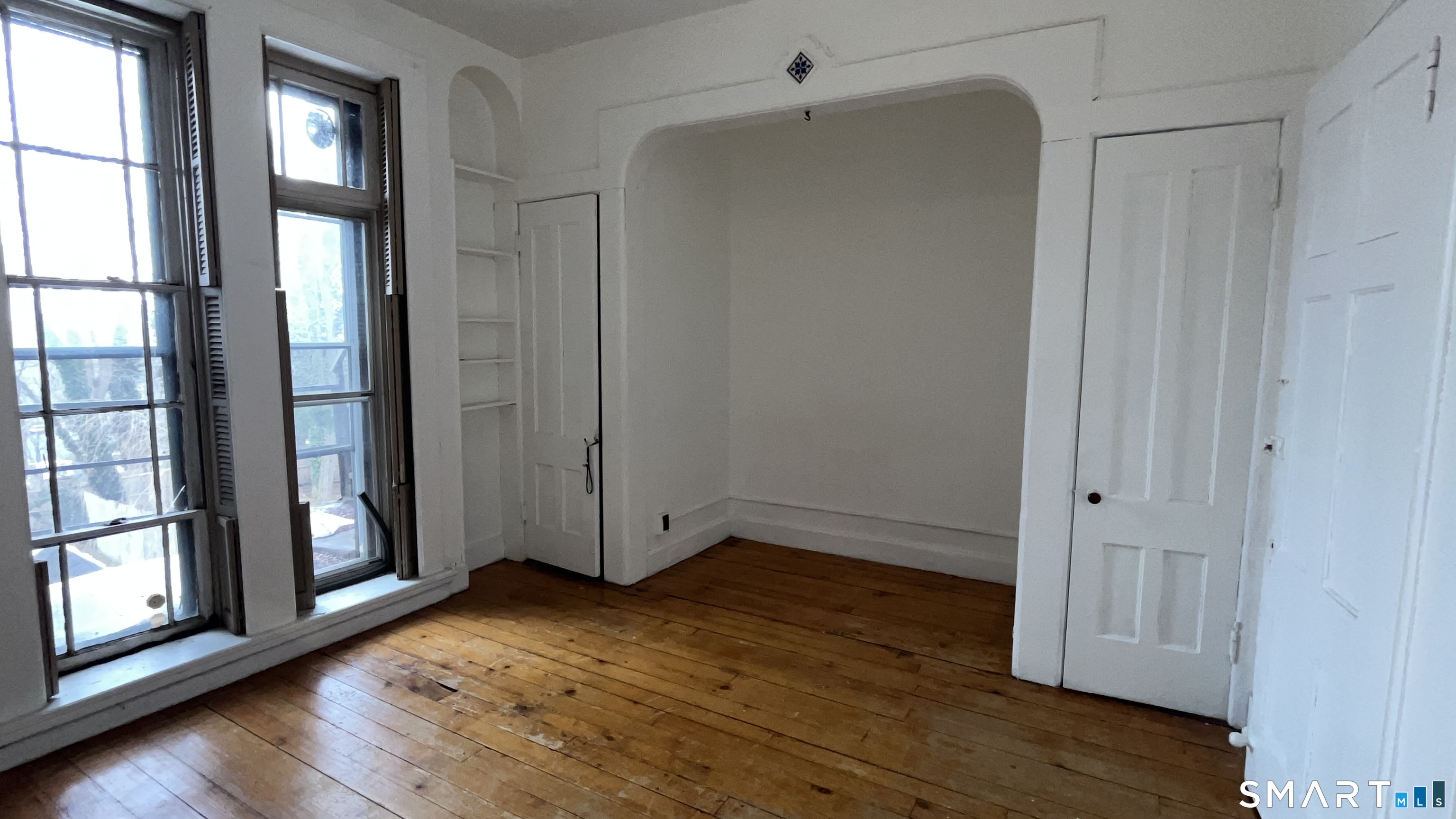 49 Edgewood Way, Unit 5 New Haven, CT 06515 - Photo 8 of 13 an empty room with wooden floor and windows
