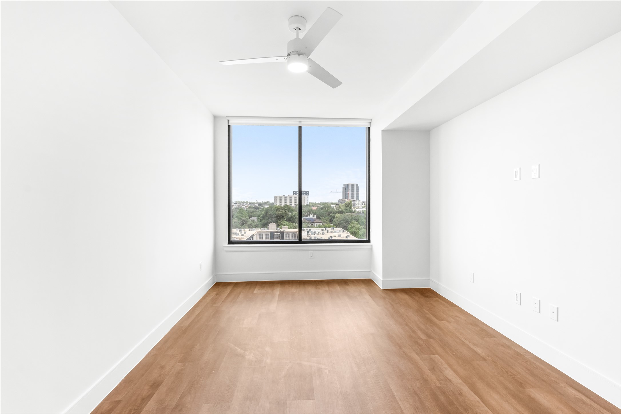 2311 Westheimer Road, Unit 714 Houston, TX 77098 - Photo 11 of 29 an empty room with wooden floor and windows