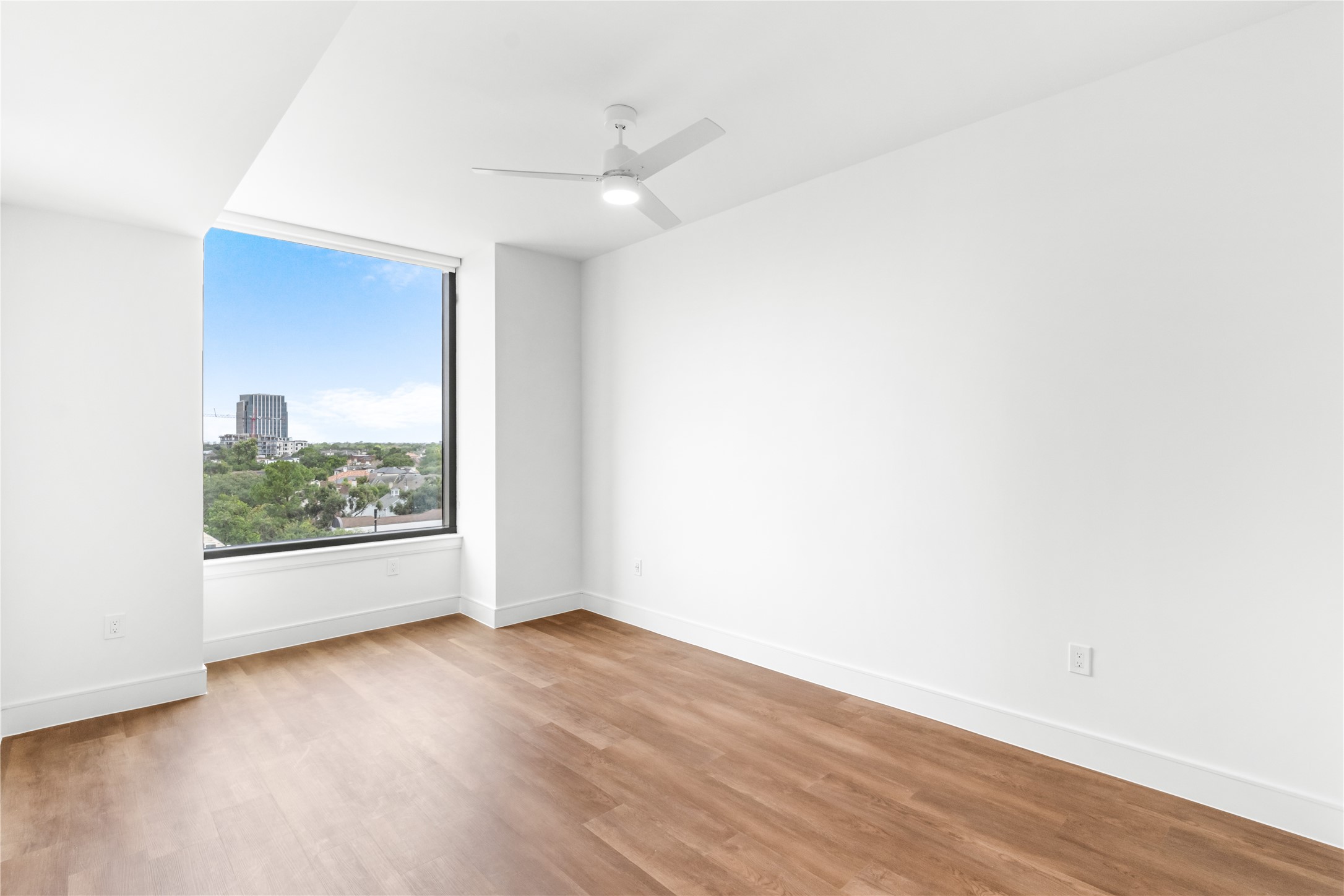 2311 Westheimer Road, Unit 714 Houston, TX 77098 - Photo 17 of 29 an empty room with wooden floor and windows
