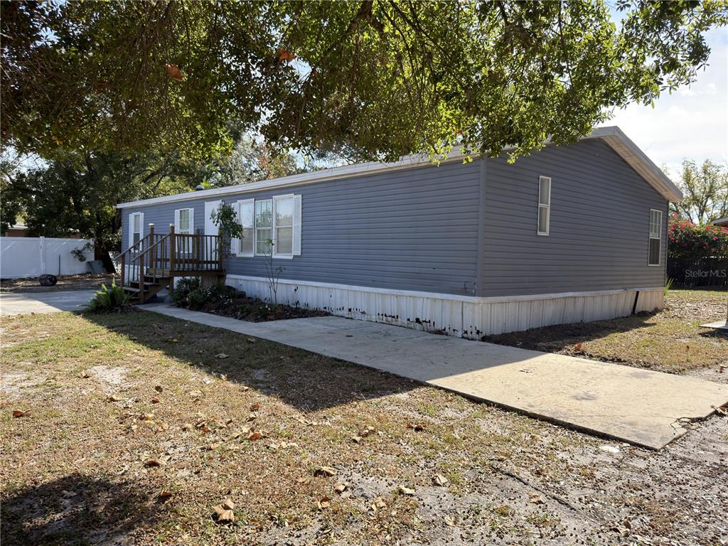 3031 Overland Road Apopka, FL 32703 - Photo 1 of 11 a backyard of a house with wooden fence and trees