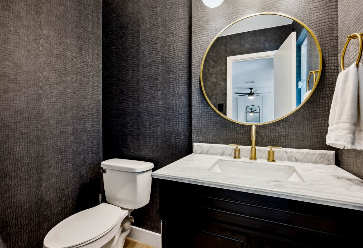 12935 Pegasus Street Austin, TX 78727 - Photo 11 of 38 A wow powder room with snake skin print wall paper, updated vanity with marble top and gold fixtures.