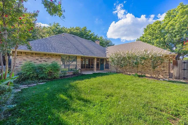 a view of house with garden space and trees