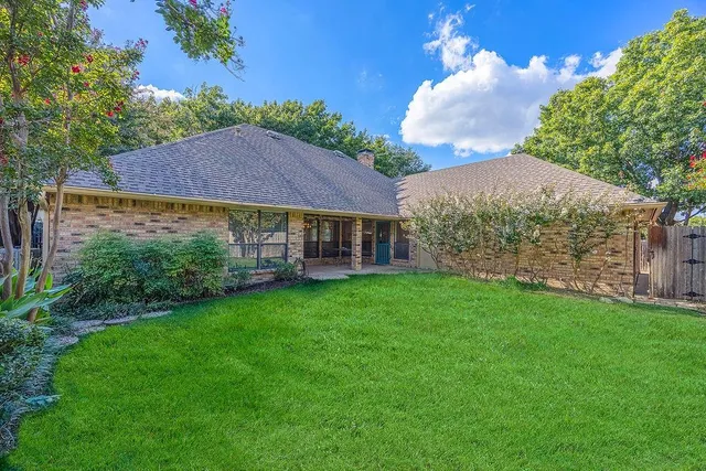 a view of house with garden space and trees