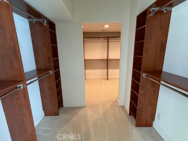 a view of walk in closet with wooden floor