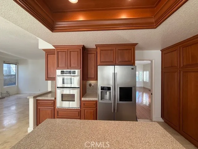 a kitchen with a refrigerator and a sink