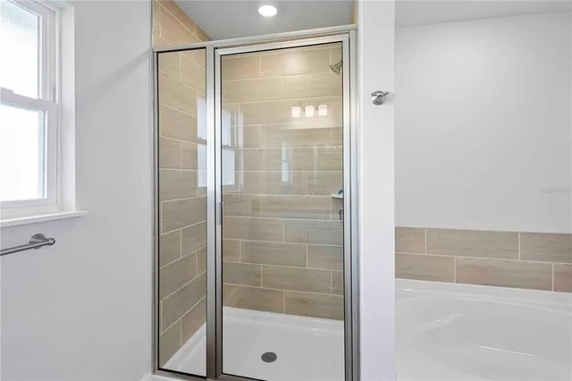 a kitchen with stainless steel appliances granite countertop a sink dishwasher and a stove top oven with wooden floor