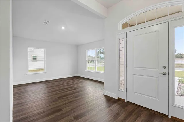 a kitchen with granite countertop a stove and a wooden floor