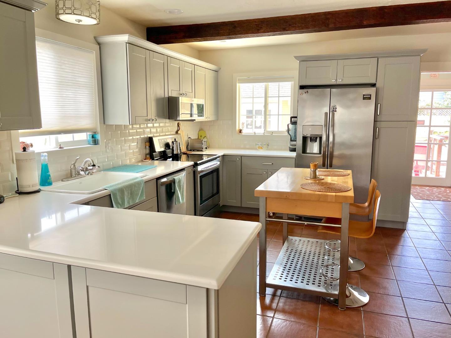 106 Maple Street Salinas, CA 93901 - Photo 8 of 22 a kitchen with a sink a stove a refrigerator cabinets and wooden floor