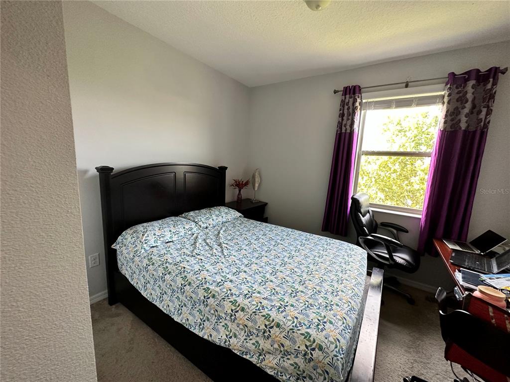 250 Rustic Loop Sanford, FL 32771 - Photo 18 of 33 a bedroom with a bed and wooden floor