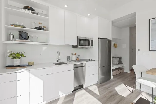 a kitchen with a sink appliances and cabinets