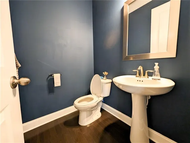a bathroom with a sink a toilet and mirror