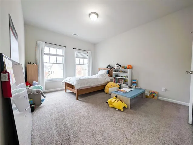 a bedroom with bed and a window