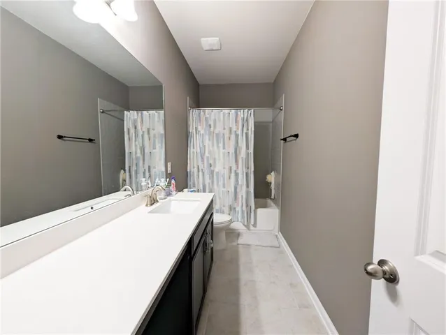 a en suite bathroom with a sink a mirror and a shower