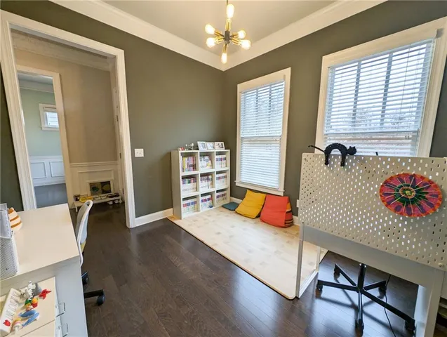 a bedroom with furniture and a large window