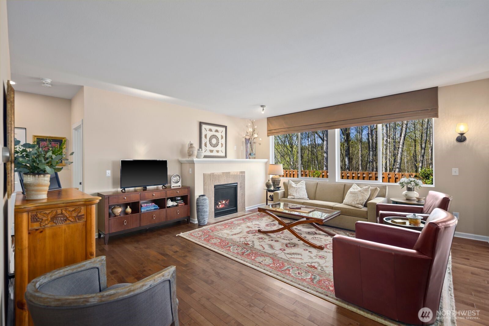 5120 South 214th Way, Unit 10 Kent, WA 98032 - Photo 6 of 39 a living room with furniture a flat screen tv and a fireplace