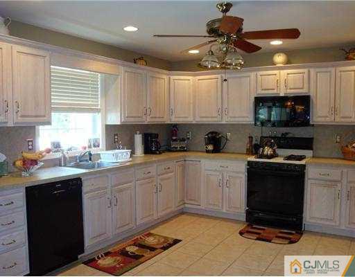 27 Hillsdale Road Edison, NJ 08820 - Photo 4 of 10 a kitchen with stainless steel appliances granite countertop a sink a stove a refrigerator cabinets and a window