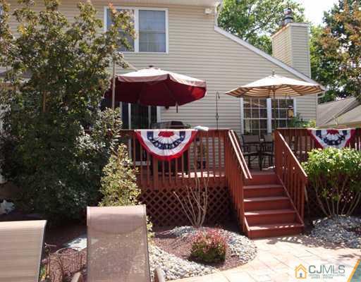 27 Hillsdale Road Edison, NJ 08820 - Photo 9 of 10 a view of a patio with table and chairs under an umbrella