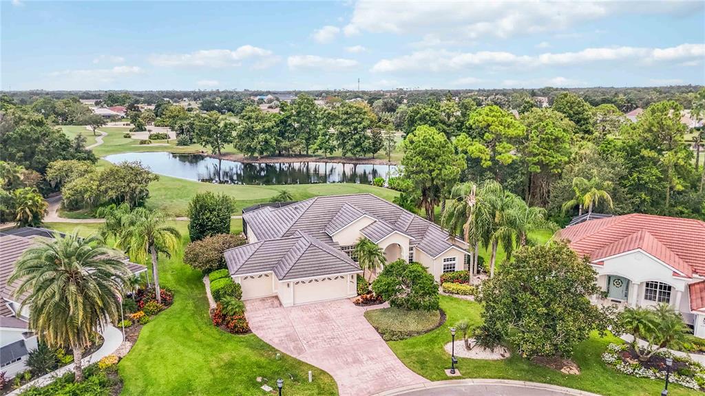 an aerial view of a house with a yard
