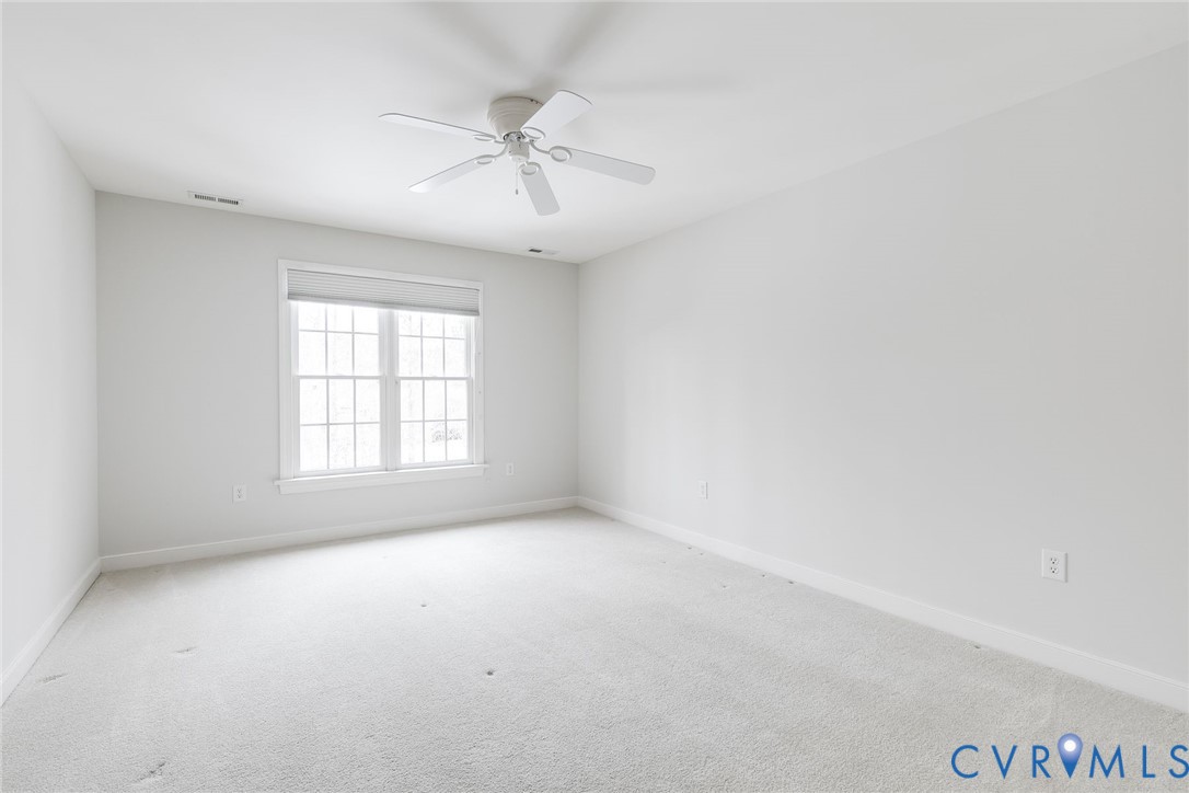 507 Hunt Field Road Manakin-Sabot, VA 23103 - Photo 35 of 43 an empty room with windows and fan