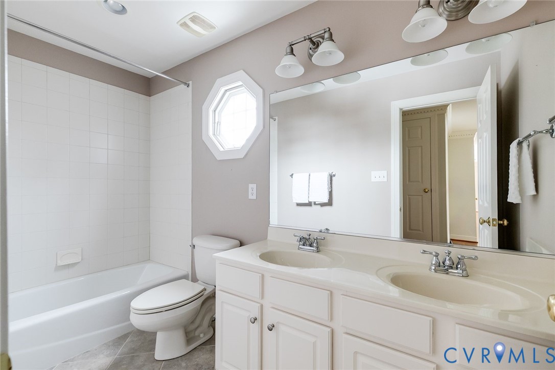 507 Hunt Field Road Manakin-Sabot, VA 23103 - Photo 37 of 43 a bathroom with a toilet a sink a mirror and bathtub